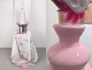 Tenderheaded is a metal tiered fondue fountain, filled instead with pink lotion, which cascades down the tiers and also spills over onto the vintage pink and blue quilt covering the box on which the fountain stands. Suspended above the fountain is a white plastic sex toy with a wheel of pink silicone tongues which spins and laps at the lotion below.