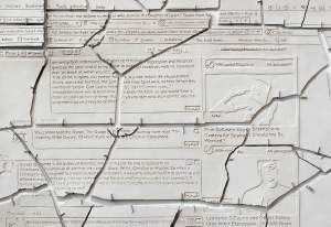 This detail photo of "obviously God.” shows clay with text and lines carved into it replicating open tabs in internet browser windows, and the clay pieces are broken apart and hung on the wall pieced together like fragments of an ancient artifact. The primary open browser window is centered on comments discussing a quote from Barack Obama about Islam.