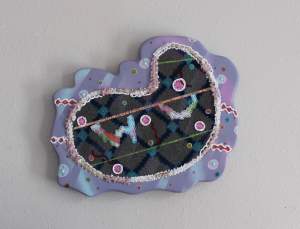 Plum Air Freshener is an abstract painting on carpet which is mounted to high density insulation foam. Cereal and antidepressants were crushed into powder and mixed into silicone caulk before piping it through cake icing tips.