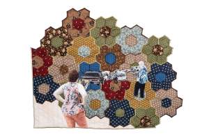 Grandmother's Garden is a patchwork quilt featuring a scene with two people and several cars, surrounded by hexagonal fabric patterns in various colors and designs.