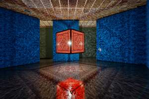 A Beautiful Despair (Orange) is an ornate, illuminated cube suspended in a room projecting intricate patterns onto blue walls and the reflective floor below.