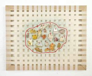 Woven muslin stretched around found frame, painted polymer clay pieces sewn on, hand sewn red embroidery.