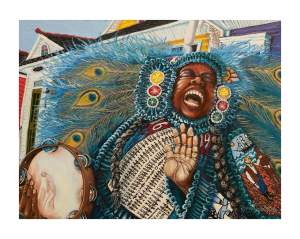 A person in Black masking Indian costume  adorned in intricate, feathered attire singing and holding a tambourine in front of New Orleans row houses.