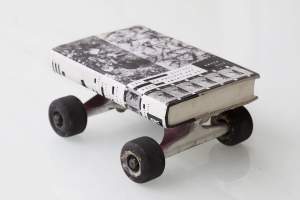 The Gesture on Pollock and Post American Art is a sculpture of a book with the same title, set on well worn skateboarding trucks and wheels. The book cover shows different views of Pollock paintings in black and white.