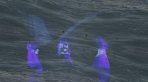 This film still from theShorein_SIGHT shows three ghostly, indigo-purple human forms that might be reflected on or veiled by rippling water. Wing-like forms span the trio, who appear to stand and face each other draped with white and vivid purple robes. The central person might clutch an infant.