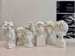 Six busts that make up [Und], Self Emancipation & Fugitivity are created with white plaster and fabric over identical head forms. All six have head wrappings that range from simple cloths tied at the nape of the neck to twisted, turban-like shapes. The bases of each bust are square or round, low or tall.