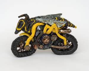 Stinger Cycle is a ceramic sculpture of a bulbous motorcycle with the body of a hornet overlaid on top.