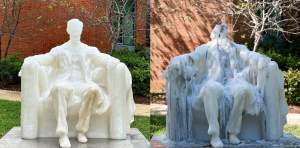 Two views of the sculpture 40 ACRES: CAMP BARKER, which is a replica in wax of the Lincoln memorial sculpture of a seated President Lincoln. On the left it is in the original state, and on the right the sculpture has been melted and deformed with trails of melted wax.