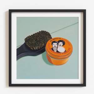 Starter Pack is a nearly square painting of an orange tin reading “Murray’s Superior Hair Dressing Pomade” with an illustration of two figures on the top, next to a coarse black brush on a light background.