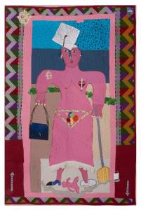 Woman I Am is a colorful quilt centered on a pink woman with a graduation cap, a burse, a broom and a baby attached by a cord. She has a heart and cross over her breast, and there is a zig zag border.