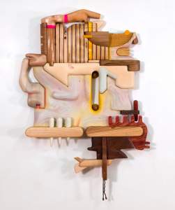 Fridge Landscape 1 is a wall sculpture composed of interlocking wooden forms in biomorphic shapes evoking stylized hands, fingers and piano keys. In two pieces, the texture of ground beef and ramen are etched into wood surface.