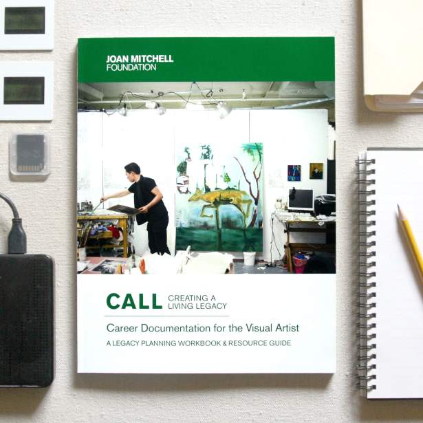 The cover of "Career Documentation for the Visual Artists" guide on a canvas with slides, hard drive, SD card and notebook