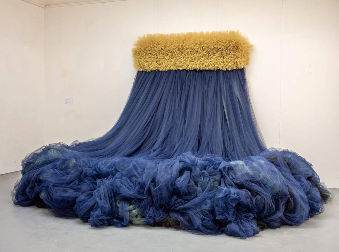 An untitled diptych with two large tangled areas of yellow, purple, green, and red brushstrokes and drips on a white ground.