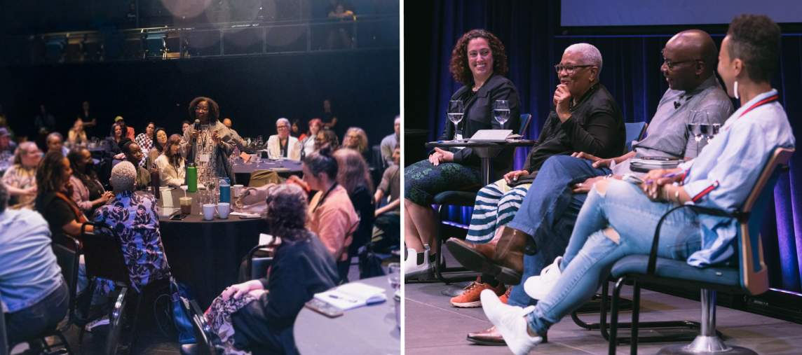 On left, a woman with dark skin tone and curly brown hair stands with a microphone, addressing the group of people sitting around the darkened room at round tables. On right, 4 people of of different ages and skin tones sit on a stage engaged in discussion. They are smiling at each other and laughing.