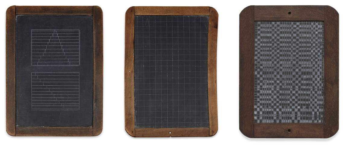 Distraction is a series of three pieces of slate housed in rounded wooden frames, with lighter gray pencil illustrations of various grids.