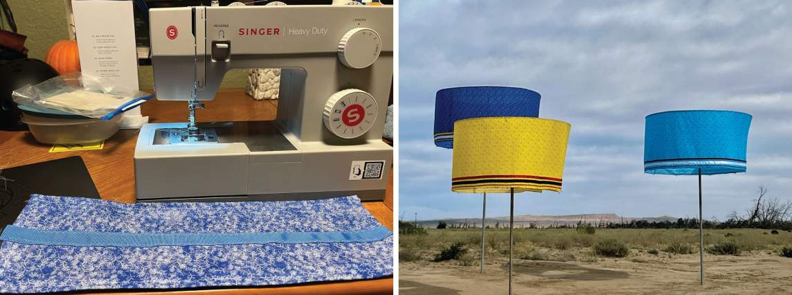 In the first of two snapshots, a mottled blue strip of cloth lies on a table in front of a Singer sewing machine. The second snapshot shows three wide, shallow cylindrical forms made of brightly colored fabric in two shades of blue or yellow. Each is suspended at the top of a pole like a lampshade, and all three poles are set into a sandy landscape.