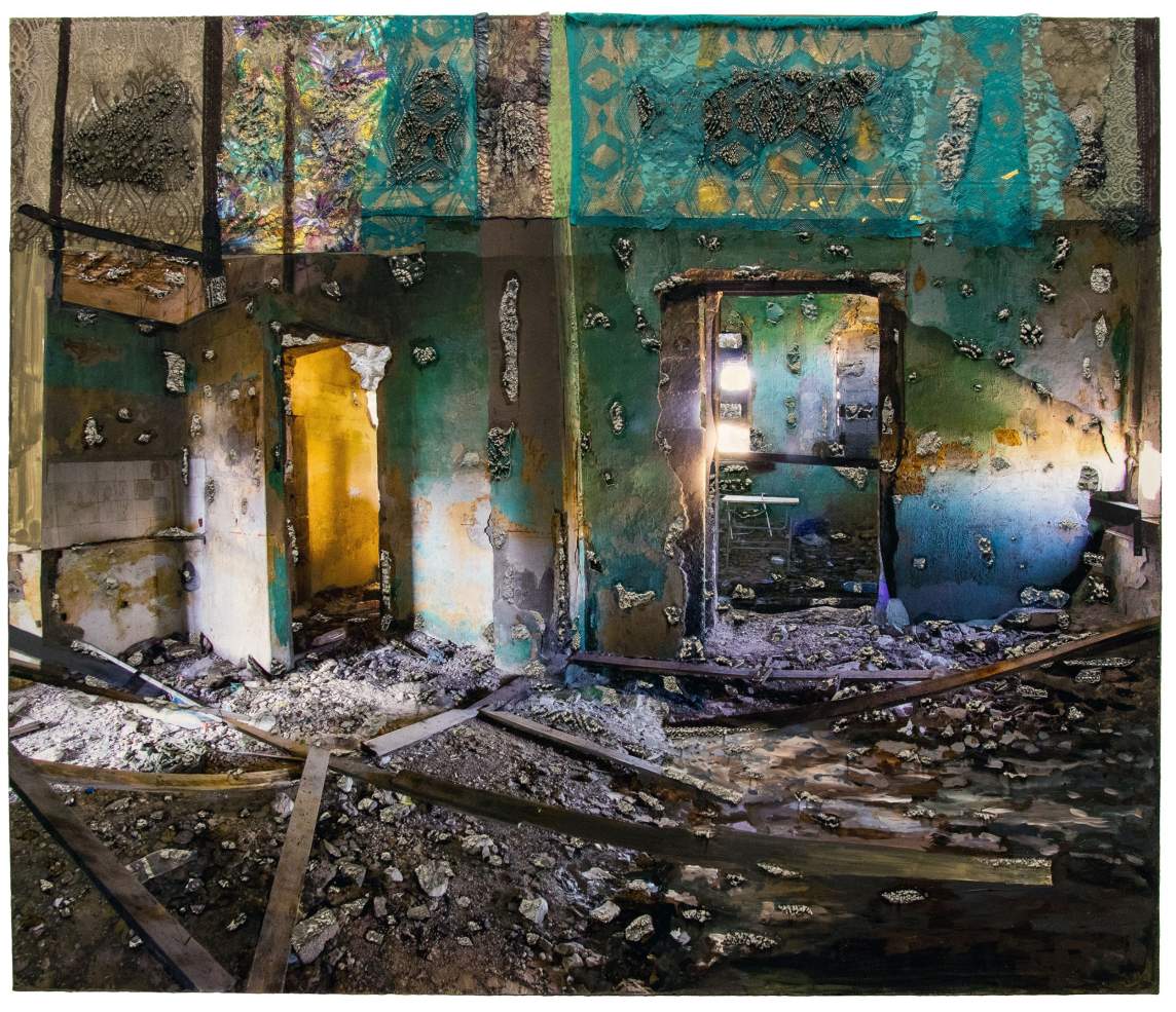 Two exits is a rectangular mixed-media artwork. In the center is a photo of a bombed-out interior with blue-green walls, two open doorways, and rubble on the floor. The artist has applied bits of colored lace and concrete to the surface of the photo.