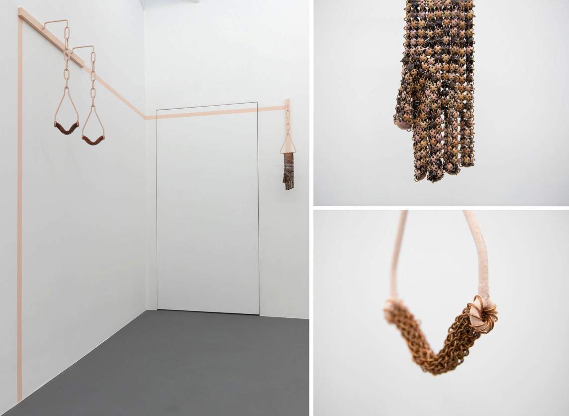 Installation view of two sculptures next to two close-ups of the pieces. A pair of handles and a metal glove hang from pink hooks and chains in the corner of a gallery. The first detail shows the glove, which is made up of tiny round disks, each pierced four times and held together with jump rings like chain mail. The handle is made entirely of interlocking rings, which is held in place with pink metal rods.