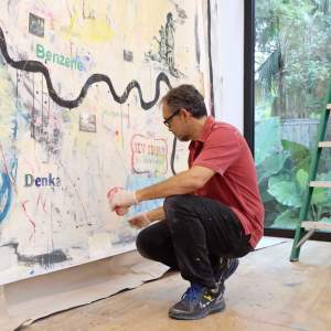 Juan Carlos Quintana painting in studio