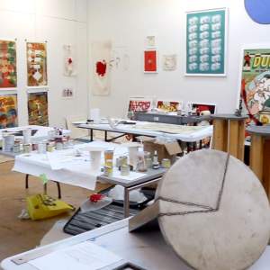 Christopher Saucedo's studio at the Joan Mitchell Center filled with artwork on walls and tables