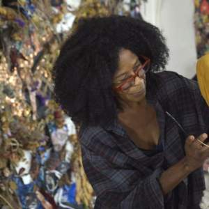Artist Kai Barrow applying materials to a sculpture