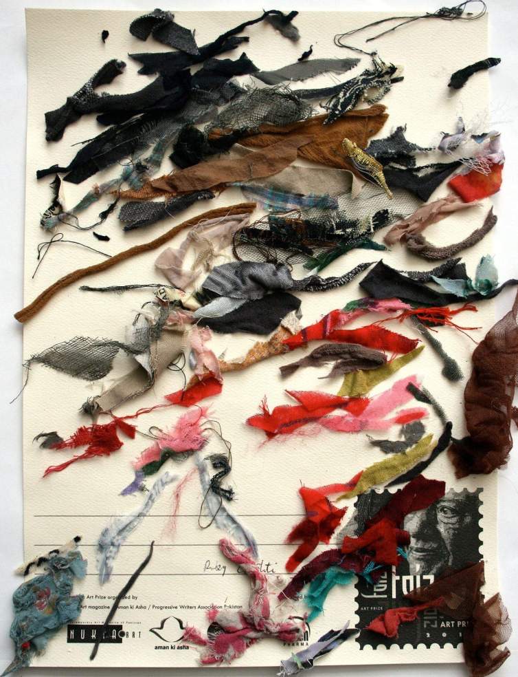 On a white postcard, with a stamp shape at bottom right, scraps of fabric are arranged in slashing horizontal marks, creating an abstract composition.