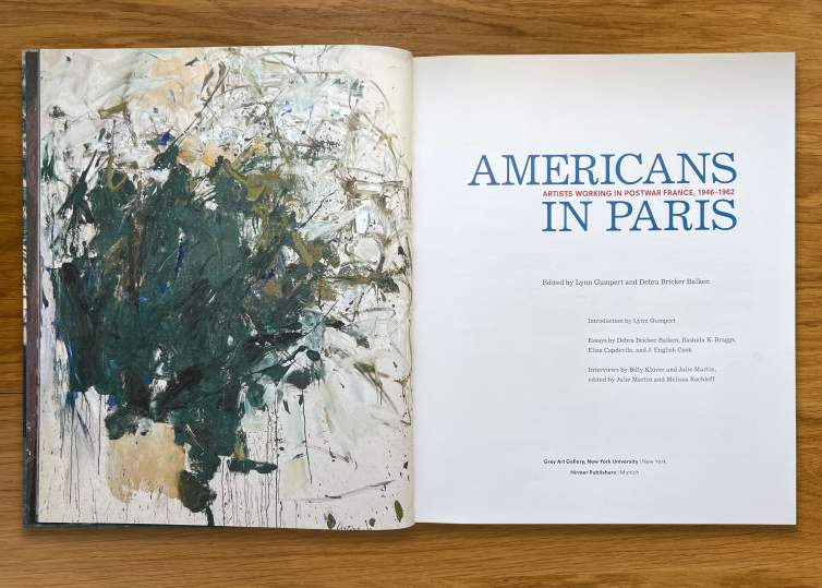 An open spread of the title page of a catalogue - the left page has an abstract painting by Joan Mitchell, and the right page reads “Americans in Paris Artists Working in Postwar France, 1946-1962” followed by author and publication details.