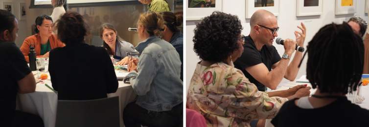 Two groups of people seated around tables engaged in discussion