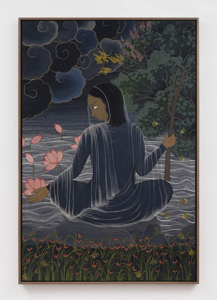 In A River of Dreams, a woman in a dark, flowing robe sits by water holding a staff, surrounded by lotus flowers, grass, trees, and swirling clouds under a dark sky.