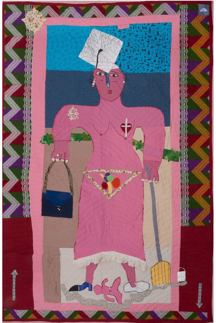 Woman I Am is a colorful quilt centered on a pink woman with a graduation cap, a purse, a broom and a baby attached by a cord. She has a heart and cross over her breast, and there is a zig zag border.