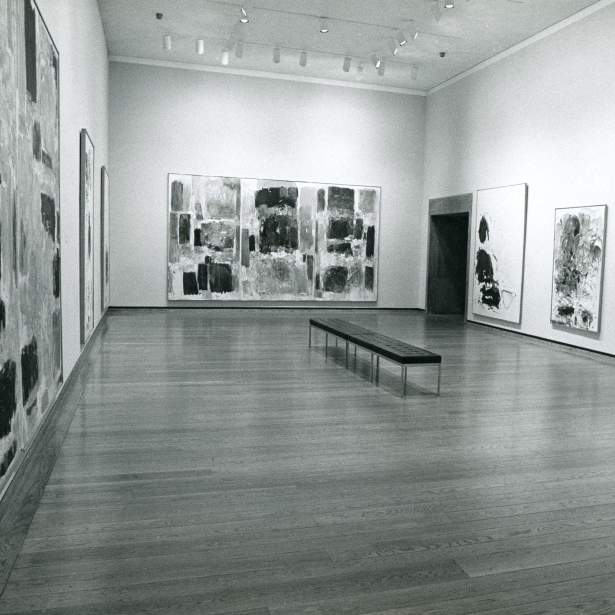 6 large abstract paintings handing in a gallery in black and white